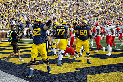 Sep 9, 2023; Ann Arbor, Michigan, USA; Michigan Wolverines defensive end Kechaun Bennett (52) celebrates running back Blake Corum   s (2) touchdown during the first half at Michigan Stadium. Mandatory Credit: David Reginek-USA TODAY Sports