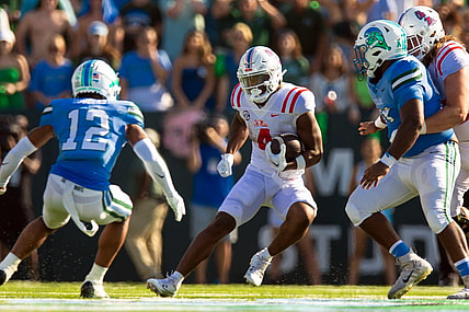 Sep 9, 2023; New Orleans, Louisiana, USA;  Mississippi Rebels running back Quinshon Judkins (4) rushes against Tulane Green Wave defensive back DJ Douglas (12) during the second half at Yulman Stadium. Mandatory Credit: Stephen Lew-USA TODAY Sports