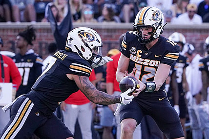 Sep 9, 2023; Columbia, Missouri, USA; Missouri Tigers quarterback Brady Cook (12) hands off to running back Cody Schrader (7) against the Middle Tennessee Blue Raiders during the first half at Faurot Field at Memorial Stadium. Mandatory Credit: Denny Medley-USA TODAY Sports
