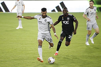 Sep 9, 2023; Washington, District of Columbia, USA; San Jose Earthquakes defender Rodrigues (26) kicks the ball away from D.C. United forward Christian Benteke (20) during the first half at Audi Field. Mandatory Credit: Amber Searls-USA TODAY Sports