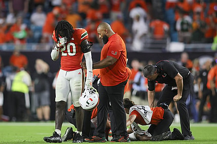 Sep 9, 2023; Miami Gardens, Florida, USA; Miami Hurricanes safety James Williams (20) reacts as trainers check on Miami Hurricanes safety Kamren Kinchens (5) after an injury against the Texas A&M Aggies during the fourth quarter at Hard Rock Stadium. Mandatory Credit: Sam Navarro-USA TODAY Sports