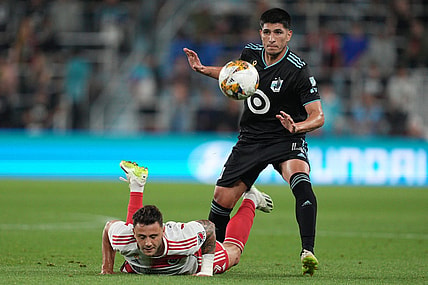 Sep 9, 2023; Saint Paul, Minnesota, USA;  New England Revolution forward Giacomo Vrioni (9) and Minnesota United defender Miguel Tapias (4) battle for the ball during the first half at Allianz Field. Mandatory Credit: Matt Blewett-USA TODAY Sports