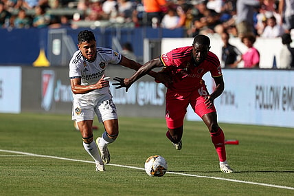 Sep 10, 2023; Carson, California, USA; St. Louis CITY SC forward Samuel Adeniran (16) controls the ball under pressure from Los Angeles Galaxy midfielder Edwin Cerrillo (20) in the first half at Dignity Health Sports Park. Mandatory Credit: Kiyoshi Mio-USA TODAY Sports