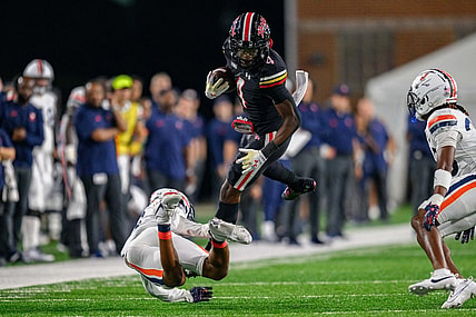 Sep 15, 2023; College Park, Maryland, USA; Maryland Terrapins wide receiver Shaleak Knotts (4) is tackled during the second quarter against the Virginia Cavaliers at SECU Stadium. Mandatory Credit: Reggie Hildred-USA TODAY Sports