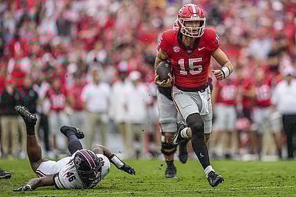Sep 16, 2023; Athens, Georgia, USA; Georgia Bulldogs quarterback Carson Beck (15) runs past South Carolina Gamecocks defensive end Bryan Thomas Jr. (46) during the first half at Sanford Stadium. Mandatory Credit: Dale Zanine-USA TODAY Sports