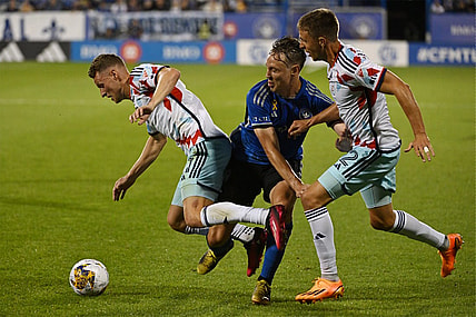 Sep 16, 2023; Montreal, Quebec, CAN; Chicago Fire forward Fabian Herbers (21) is tackled by CF Montreal midfielder Lassi Lappalainen (21) in the first half at Stade Saputo. Mandatory Credit: David Kirouac-USA TODAY Sports