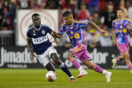 Sep 16, 2023; Toronto, Ontario, CAN; Toronto FC forward Lorenzo Insigne (24) moves the ball against Vancouver Whitecaps defender Richie Laryea (7) during the first half at BMO Field. Mandatory Credit: Kevin Sousa-USA TODAY Sports