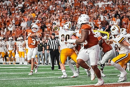 Texas Longhorns quarterback Quinn Ewers (3) throws a touchdown pass to Texas Longhorns defensive lineman Byron Murphy II (90) during the Texas Longhorns' game against the Wyoming Cowboys, Saturday, Sept. 16 at Darrell K Royal   Texas Memorial Stadium in Austin.