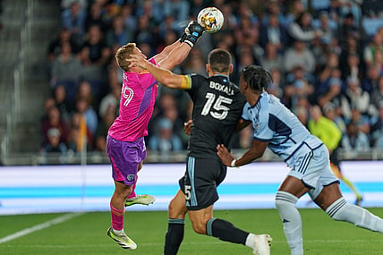 Sep 16, 2023; Saint Paul, Minnesota, USA; Sporting Kansas City goalkeeper Tim Melia (29) punches the ball away on a free kick in the first half with Minnesota United defender Michael Boxall (15) pressing at Allianz Field. Mandatory Credit: Matt Blewett-USA TODAY Sports