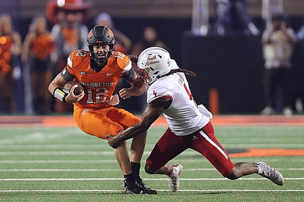 Sep 16, 2023; Stillwater, Oklahoma, USA; Oklahoma State Cowboys quarterback Gunnar Gundy (12) tries to get past South Alabama Jaguars linebacker James Miller (4) during an NCAA football game between Oklahoma State and South Alabama at Boone Pickens Stadium. South Alabama won 33-7. Mandatory Credit: Bryan Terry-USA TODAY Sports