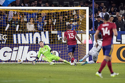 Sep 16, 2023; San Jose, California, USA; Real Salt Lake goalkeeper Zac MacMath (in green) allows a goal by San Jose Earthquakes forward Jeremy Ebobisse (right in gray) during the first half at PayPal Park. Mandatory Credit: Darren Yamashita-USA TODAY Sports