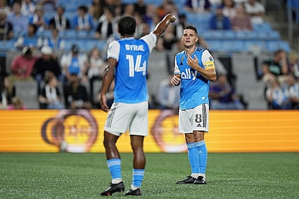 Sep 20, 2023; Charlotte, North Carolina, USA; Charlotte FC midfielder Ashley Westwood (8) talks with defender Nathan Byrne (14) during the first half at Bank of America Stadium. Mandatory Credit: Jim Dedmon-USA TODAY Sports