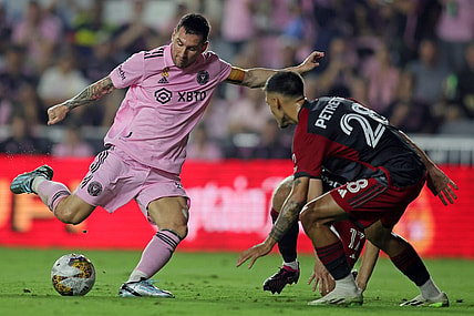 Sep 20, 2023; Fort Lauderdale, Florida, USA; Inter Miami forward Lionel Messi (10) shoots the ball against Toronto FC defender Raoul Petretta (28) during the first half at DRV PNK Stadium. Mandatory Credit: Sam Navarro-USA TODAY Sports