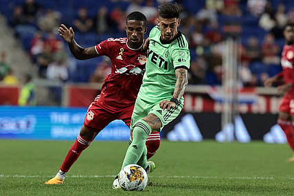 Sep 20, 2023; Harrison, New Jersey, USA; Austin FC midfielder Emiliano Rigoni (7) and New York Red Bulls defender Kyle Duncan (6) battle for the ball in the second half at Red Bull Arena. Mandatory Credit: Vincent Carchietta-USA TODAY Sports
