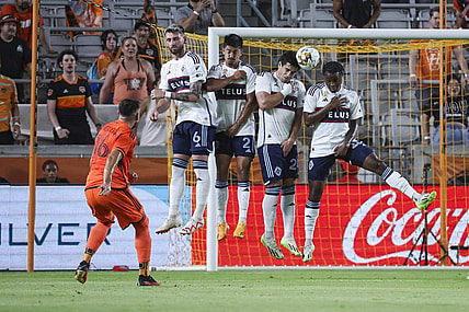Sep 20, 2023; Houston, Texas, USA; Houston Dynamo FC midfielder Hector Herrera (16) shoots the ball past Vancouver Whitecaps FC defenders to score a goal during the first half at Shell Energy Stadium. Mandatory Credit: Troy Taormina-USA TODAY Sports