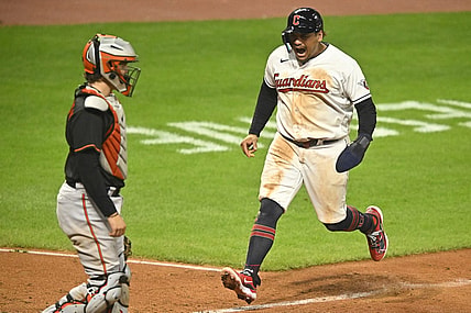 Sep 22, 2023; Cleveland, Ohio, USA; Cleveland Guardians first baseman Josh Naylor (22) scores beside Baltimore Orioles catcher Adley Rutschman (35) in the seventh inning at Progressive Field. Mandatory Credit: David Richard-USA TODAY Sports
