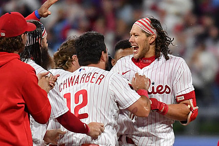 Sep 22, 2023; Philadelphia, Pennsylvania, USA; Philadelphia Phillies first baseman Alec Bohm (28) celebrates his walk-off single with teammates during the tenth inning against the New York Mets at Citizens Bank Park. Mandatory Credit: Eric Hartline-USA TODAY Sports