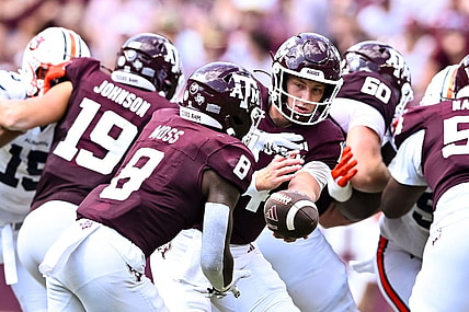 Sep 23, 2023; College Station, Texas, USA; Texas A&M Aggies quarterback Max Johnson (14) hands off the ball to running back Le'Veon Moss (8) during the third quarter against the Auburn Tigers at Kyle Field. Mandatory Credit: Maria Lysaker-USA TODAY Sports