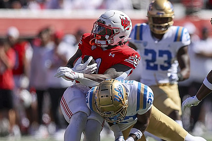 Sep 23, 2023; Salt Lake City, Utah, USA; UCLA Bruins defensive back Kamari Ramsey (27) tackles Utah Utes running back Jaylon Glover (1) in the second quarter at Rice-Eccles Stadium. Mandatory Credit: Rob Gray-USA TODAY Sports