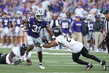 Sep 23, 2023; Manhattan, Kansas, USA; UCF Knights defensive back Nikai Martinez (21) misses a tackle on Kansas State Wildcats running back DJ Giddens (31) during the first quarter at Bill Snyder Family Football Stadium. Mandatory Credit: Scott Sewell-USA TODAY Sports