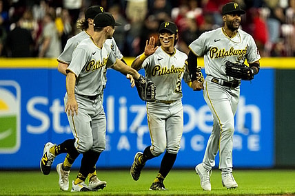 Sep 23, 2023; Cincinnati, Ohio, USA; Pittsburgh Pirates second baseman Ji Hwan Bae (3) high fives left fielder Bryan Reynolds (10) as right fielder Joshua Palacios (54), right runs ahead of them after winning at Great American Ball Park. Mandatory Credit: The Cincinnati Enquirer-USA TODAY Sports