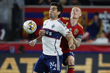 Sep 23, 2023; Sandy, Utah, USA; Vancouver Whitecaps forward Brian White (24) and Real Salt Lake defender Justen Glad (15) battle in the second half at America First Field. Mandatory Credit: Jeff Swinger-USA TODAY Sports