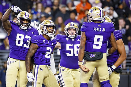 Sep 23, 2023; Seattle, Washington, USA; Washington Huskies wide receiver JaLynn Polk (2) celebrates with tight end Devin Culp (83), offensive lineman Geirean Hatchett (56) and quarterback Michael Penix Jr. (9) after catching a touchdown pass against the California Golden Bears during the second quarter at Alaska Airlines Field at Husky Stadium. Mandatory Credit: Joe Nicholson-USA TODAY Sports