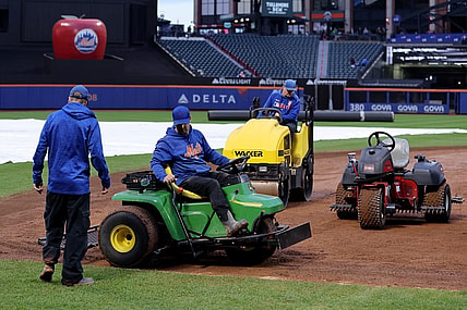 Sep 26, 2023; New York City, New York, USA; Members of the grounds crew attempt to dry the field during a delayed start before a game between the New York Mets and Miami Marlins at Citi Field. Mandatory Credit: Brad Penner-USA TODAY Sports