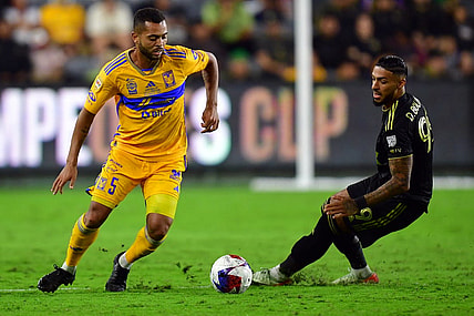 Sep 27, 2023; Los Angeles, CA, USA; Los Angeles FC forward Denis Bouanga (99) and Tigres UANL midfielder Rafael Carioca (5) battle for the ball in the second half at BMO Stadium. Mandatory Credit: Gary A. Vasquez-USA TODAY Sports