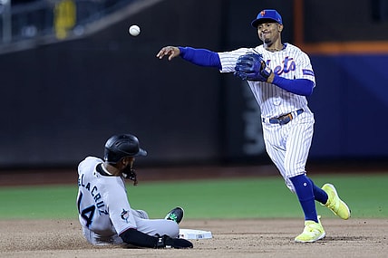 Sep 28, 2023; New York City, New York, USA; New York Mets shortstop Francisco Lindor (12) steps on second to force out Miami Marlins right fielder Bryan De La Cruz (14) and throws to first to attempt a double play on a ball hit by Marlins shortstop Garrett Hampson (not pictured) during the second inning at Citi Field. Hampson was safe at first on the play. Mandatory Credit: Brad Penner-USA TODAY Sports