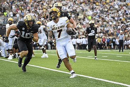 Sep 30, 2023; Nashville, Tennessee, USA; Missouri Tigers running back Cody Schrader (7) scores on a one-yard run against the Vanderbilt Commodores during the first half at FirstBank Stadium. Mandatory Credit: Steve Roberts-USA TODAY Sports