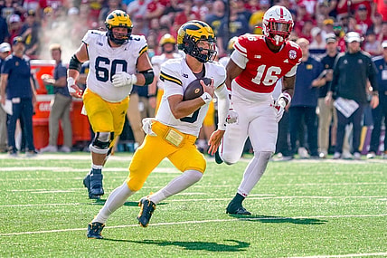 Sep 30, 2023; Lincoln, Nebraska, USA; Michigan Wolverines quarterback J.J. McCarthy (9) runs for a touchdown against Nebraska Cornhuskers defensive lineman Elijah Jeudy (16) during the second quarter at Memorial Stadium. Mandatory Credit: Dylan Widger-USA TODAY Sports