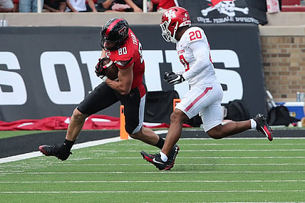 Sep 30, 2023; Lubbock, Texas, USA; Texas Tech Red Raiders tight end Mason Tharp (80) rushes against Houston Cougars defensive safety Antonio Brooks (20) in the first half at Jones AT&T Stadium and Cody Campbell Field. Mandatory Credit: Michael C. Johnson-USA TODAY Sports