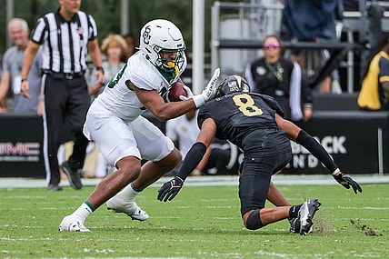 Sep 30, 2023; Orlando, Florida, USA; Baylor Bears tight end Drake Dabney (89) avoids a tackle against UCF Knights defensive back Demari Henderson (8) during the second quarter at FBC Mortgage Stadium. Mandatory Credit: Mike Watters-USA TODAY Sports