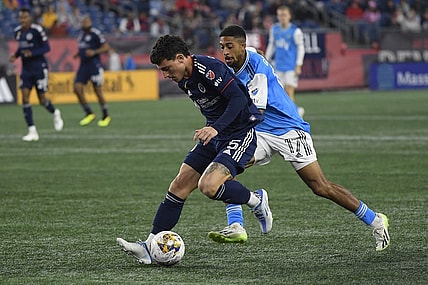 Sep 30, 2023; Foxborough, Massachusetts, USA;  New England Revolution forward Tom s Chancalay (5) and Charlotte FC midfielder McKinze Gaines (17) battle for the ball during the first half at Gillette Stadium. Mandatory Credit: Bob DeChiara-USA TODAY Sports