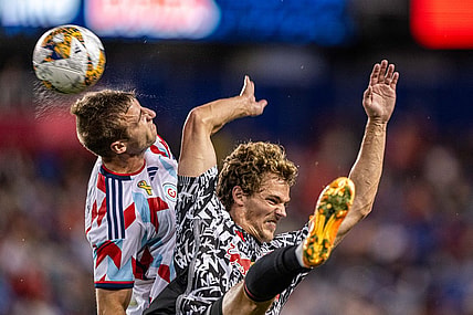 Sep 30, 2023; Harrison, New Jersey, USA; Chicago Fire defender Wyatt Omsberg (left) jumps to head the ball against New York Red Bulls forward Tom Barlow (right) during the first half at Red Bull Arena. Mandatory Credit: Mark Smith-USA TODAY Sports