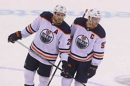 Dec 31, 2021; Newark, New Jersey, USA; Edmonton Oilers center Leon Draisaitl (29) and Edmonton Oilers center Connor McDavid (97) talk during overtime of their game against the New Jersey Devils at Prudential Center. Mandatory Credit: Ed Mulholland-USA TODAY Sports