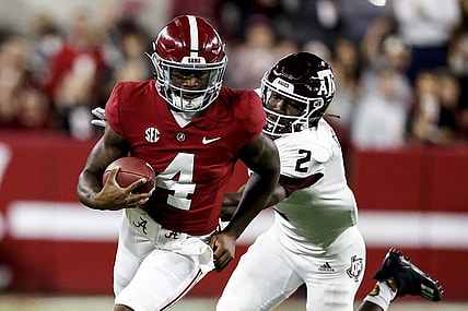 Oct 8, 2022; Tuscaloosa, Alabama, USA;  Alabama Crimson Tide quarterback Jalen Milroe (4) scrambles for yardage against Texas A&M Aggies defensive back Denver Harris (2) during the first half at Bryant-Denny Stadium. Mandatory Credit: Butch Dill-USA TODAY Sports