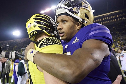Nov 12, 2022; Eugene, Oregon, USA; Washington Huskies quarterback Michael Penix Jr. (9) embraces Oregon Ducks quarterback Bo Nix (10) after a game at Autzen Stadium. The Huskies won the game 37-34.  Mandatory Credit: Troy Wayrynen-USA TODAY Sports