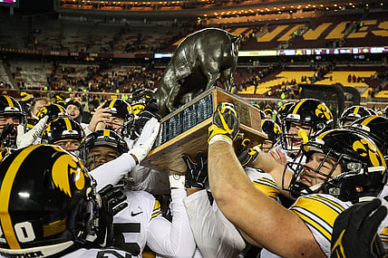 Nov 19, 2022; Minneapolis, Minnesota, USA; Iowa Hawkeyes players celebrate with the Floyd of Rosedale after defeating the Minnesota Golden Gophers at Huntington Bank Stadium. Mandatory Credit: Matt Krohn-USA TODAY Sports