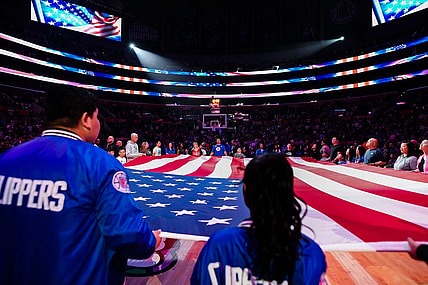 Apr 8, 2023; Los Angeles, California, USA; LA Clippers fans hold the American flag during a pre-game ceremony against the Portland Trail Blazers at Crypto.com Arena. Mandatory Credit: Jonathan Hui-USA TODAY Sports