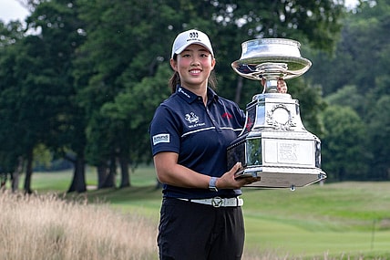 Jun 25, 2023; Springfield, New Jersey, USA; Ruoning Yin raises the championship trophy after winning the KPMG Women's PGA Championship golf tournament. Mandatory Credit: John Jones-USA TODAY Sports
