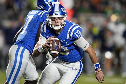 Sep 30, 2023; Durham, North Carolina, USA; Duke Blue Devils quarterback Riley Leonard (13) is forced to run during the second quarter against the Notre Dame Fighting Irish at Wallace Wade Stadium. Mandatory Credit: Jim Dedmon-USA TODAY Sports
