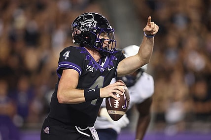 Sep 30, 2023; Fort Worth, Texas, USA; TCU Horned Frogs quarterback Chandler Morris (4) rolls out to pass against West Virginia Mountaineers defensive lineman Tomiwa Durojaiye (3) in the second quarter at Amon G. Carter Stadium. Mandatory Credit: Tim Heitman-USA TODAY Sports