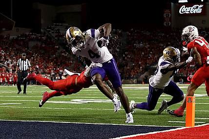 Sep 30, 2023; Tucson, Arizona, USA; Washington Huskies wide receiver Germie Bernard (4) scores a touchdown in the first half at Arizona Stadium. Mandatory Credit: Zachary BonDurant-USA TODAY Sports