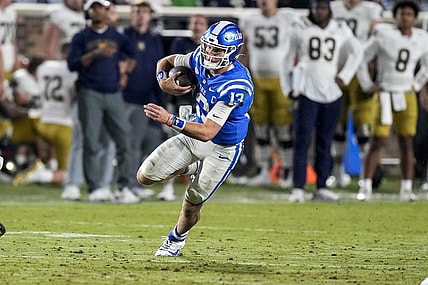 Sep 30, 2023; Durham, North Carolina, USA; Duke Blue Devils quarterback Riley Leonard (13) runs a keeper during the second half against the Notre Dame Fighting Irish at Wallace Wade Stadium. Mandatory Credit: Jim Dedmon-USA TODAY Sports