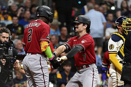 Oct 3, 2023; Milwaukee, Wisconsin, USA; Arizona Diamondbacks shortstop Geraldo Perdomo (2) and left fielder Corbin Carroll (7) celebrate scoring in the third inning against the Milwaukee Brewers during game one of the Wildcard series for the 2023 MLB playoffs at American Family Field. Mandatory Credit: Michael McLoone-USA TODAY Sports