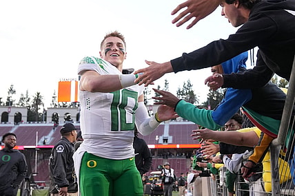 Sep 30, 2023; Stanford, California, USA; Oregon Ducks quarterback Bo Nix (10) celebrates with fans after defeating the Stanford Cardinal at Stanford Stadium. Mandatory Credit: Darren Yamashita-USA TODAY Sports