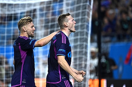 Oct 4, 2023; Charlotte, North Carolina, USA; Charlotte FC forward Karol   widerski (11) celebrates with midfielder Kamil J    wiak (7) after scoring his second goal in the first half at Bank of America Stadium. Mandatory Credit: Bob Donnan-USA TODAY Sports