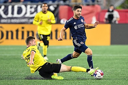 Oct 4, 2023; Foxborough, Massachusetts, USA; Columbus Crew midfielder Sean Zawadzki (25) defends New England Revolution midfielder Carles Gil (10) during the first half at Gillette Stadium. Mandatory Credit: Brian Fluharty-USA TODAY Sports